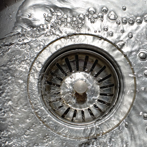 Sink drain with water