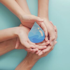 Hands holding a paper water drop