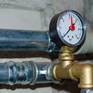 Close up of plumbing pipes with monitor
