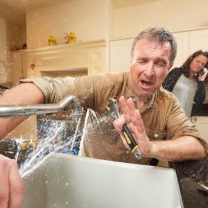 A man struggling with his kitchen sink