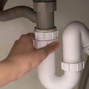 A man inspecting a pipe