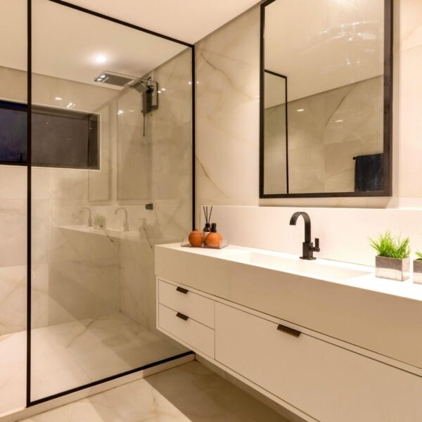 A modern bathroom with vanity and shower.
